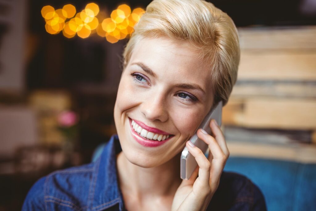 lady smiling while talking to her phone